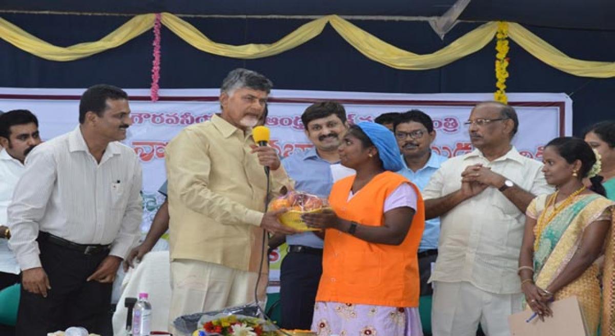 Chief Minister N Chandrababu Naidu complementing an employee of Sahi Exports in Kuppam on Monday. Minister B Gopalakrishna Reddy and District Collector Siddharth Jain are also seen 