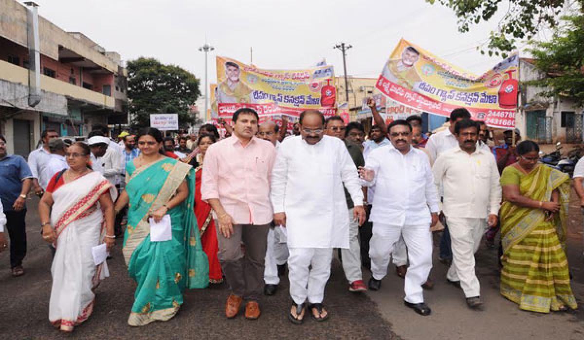 City MLA Dr Akula Satyanarayana, MLC Adireddy Apparao and other officials taking part in a rally to spread awareness on Deepam scheme in Rajamahendravaram on Thursday
