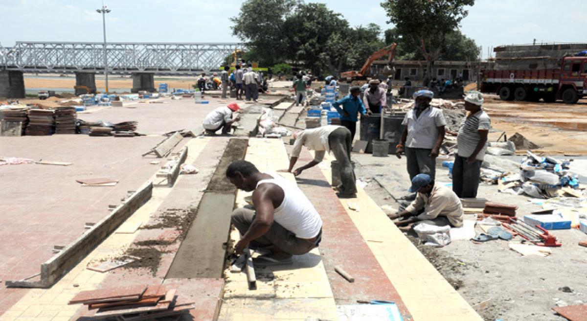 Workers racing against time to complete the bathing ghat works at Padmavathi ghat in Vijayawada on Monday
Photo: Ch Venkata Mastan
