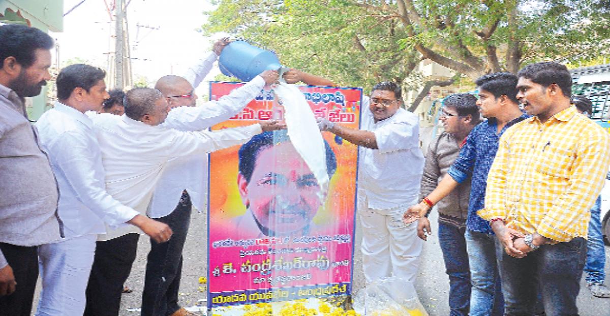 Yavabheri  members performing Palabhishekam  to the portrait  of Telangana Chief  Minister K Chandrashekar Rao in Vijayawada  on Tuesday