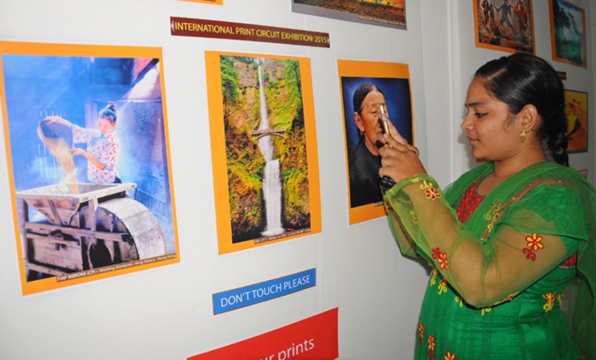 A woman going round the JCM International Print Circuit Exhibition-2015 at Aakriti Art Gallery