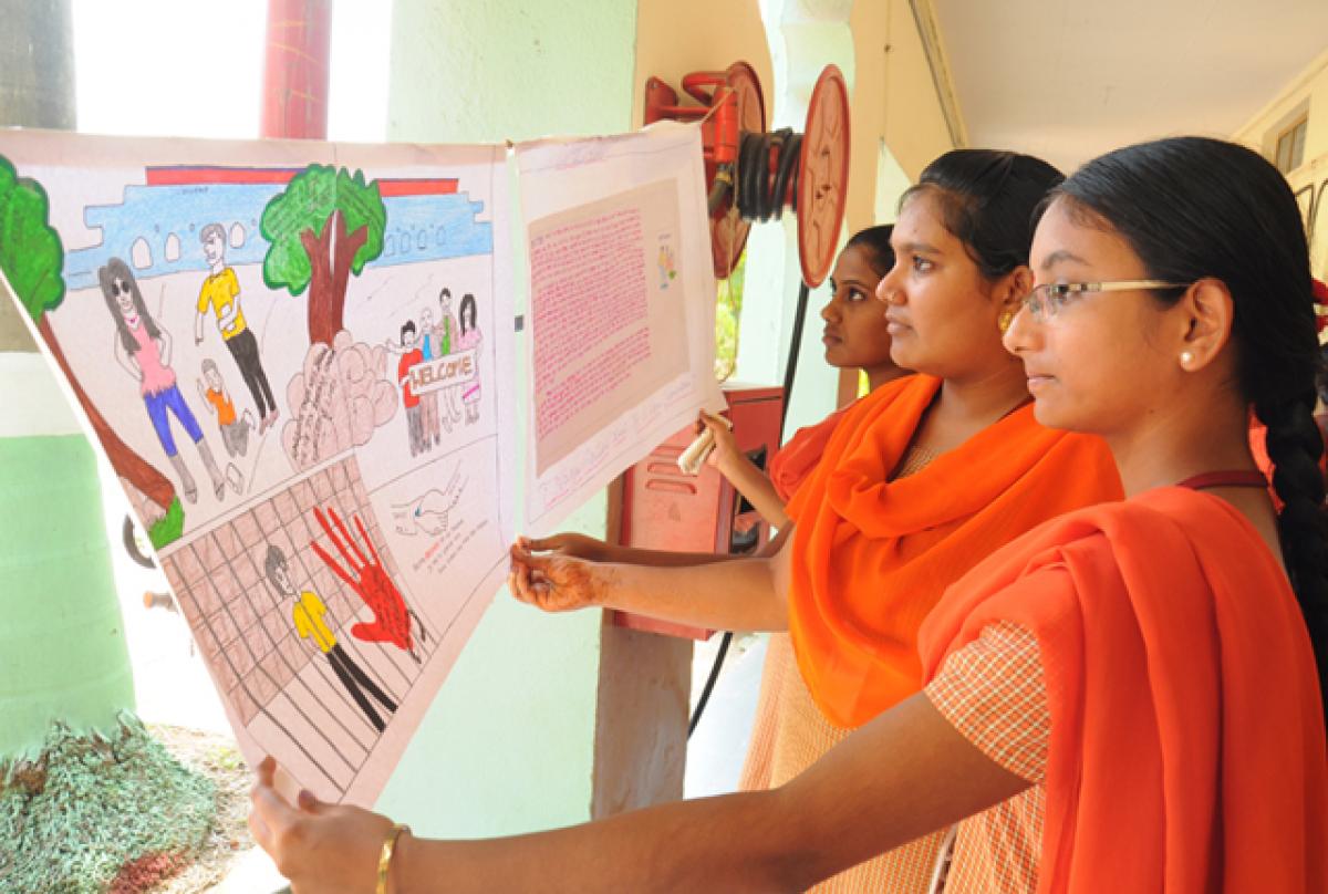 Students taking part in poster presentation and slogan writing competitions against ragging at Sri Durga Malleswara Siddhartha Mahila Kalasala
