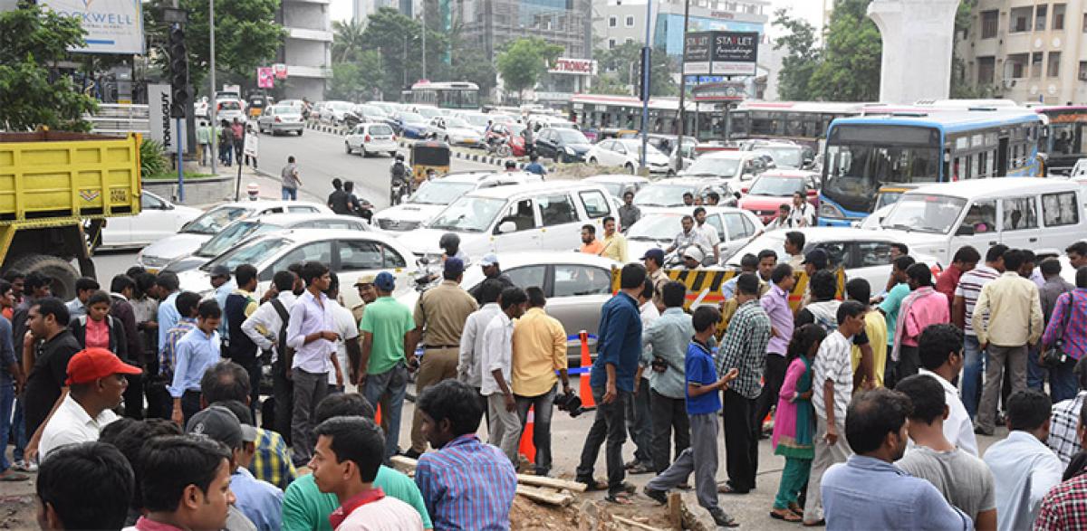 Traffic comes to a standstill at the scene of action at Road Number 36, Jubilee Hills in Hyderabad on Thursday.
