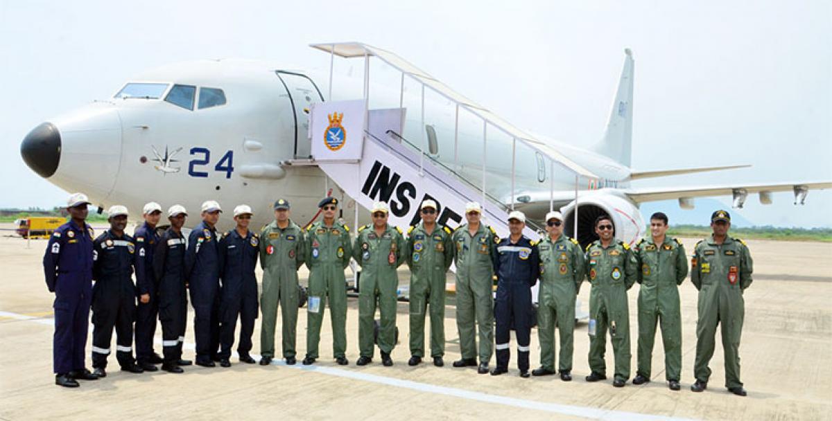 Navy pilots and INS Dega officials pose for a picture with P8I,  a long range aircraft, in Visakhapatnam on Thursday