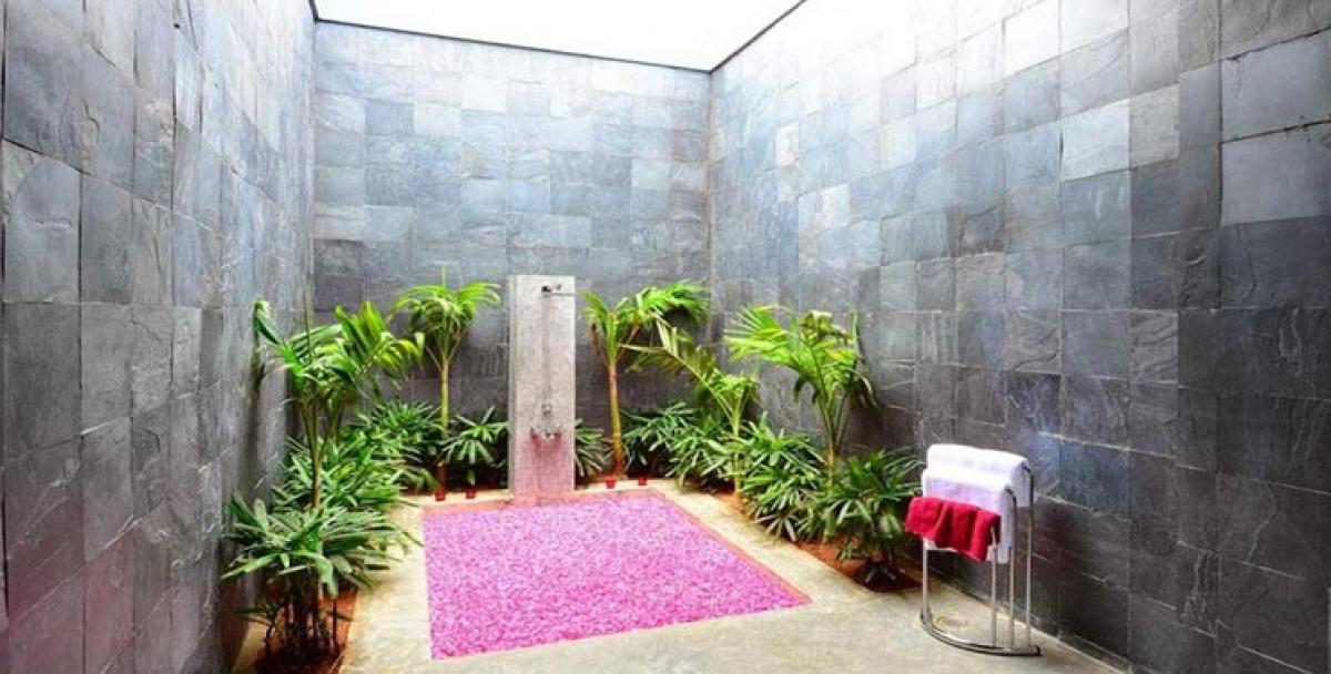 The bedroom is a warm and compact space wherein the bed is a raised platform made of cement. The  stone-finished fiber tiles and white surfaces provide a very soothing ambiance.