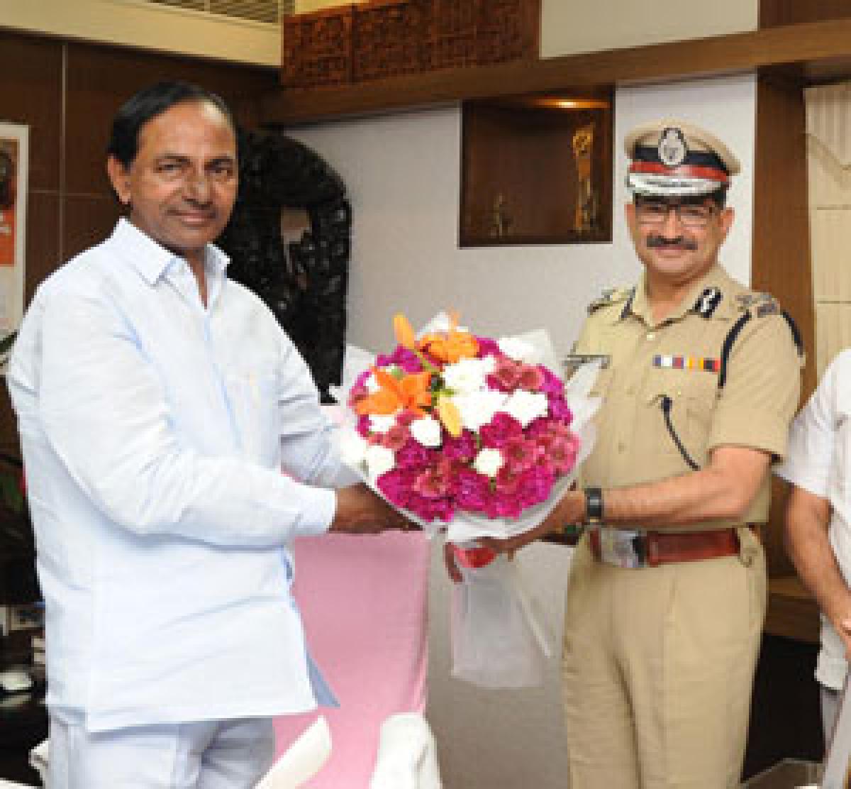 Telangana DGP Anurag Sharma presenting a bouquet to Chief Minister   K Chandrashekar Rao on Friday after being appointed as the DGP with full charge. Chief Secretary Rajiv Sharma, Hyderabad Police Commissioner  M Mahender Reddy and Intelligence IG B Shivadhar Reddy are also seen