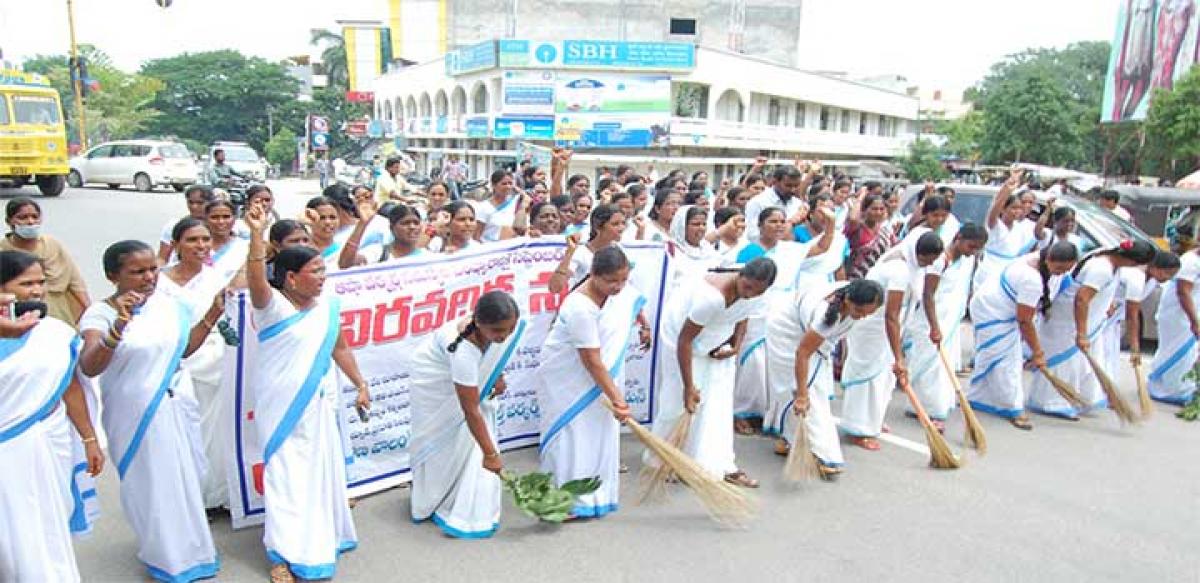 Protesting Asha workers sweeping roads in Hanamkonda on Saturday