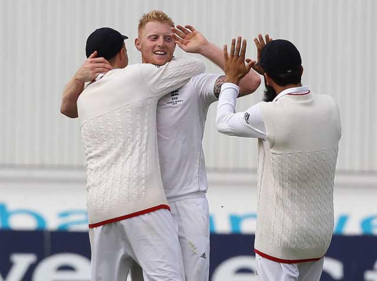 England&rsquo;s  Ben Stokes(centre) celebrates with teammates after taking the wicket of Australia&rsquo;s opener David Warner(not in the picture) on the second day of the fourth Ashes Test at Trent Bridge on Friday