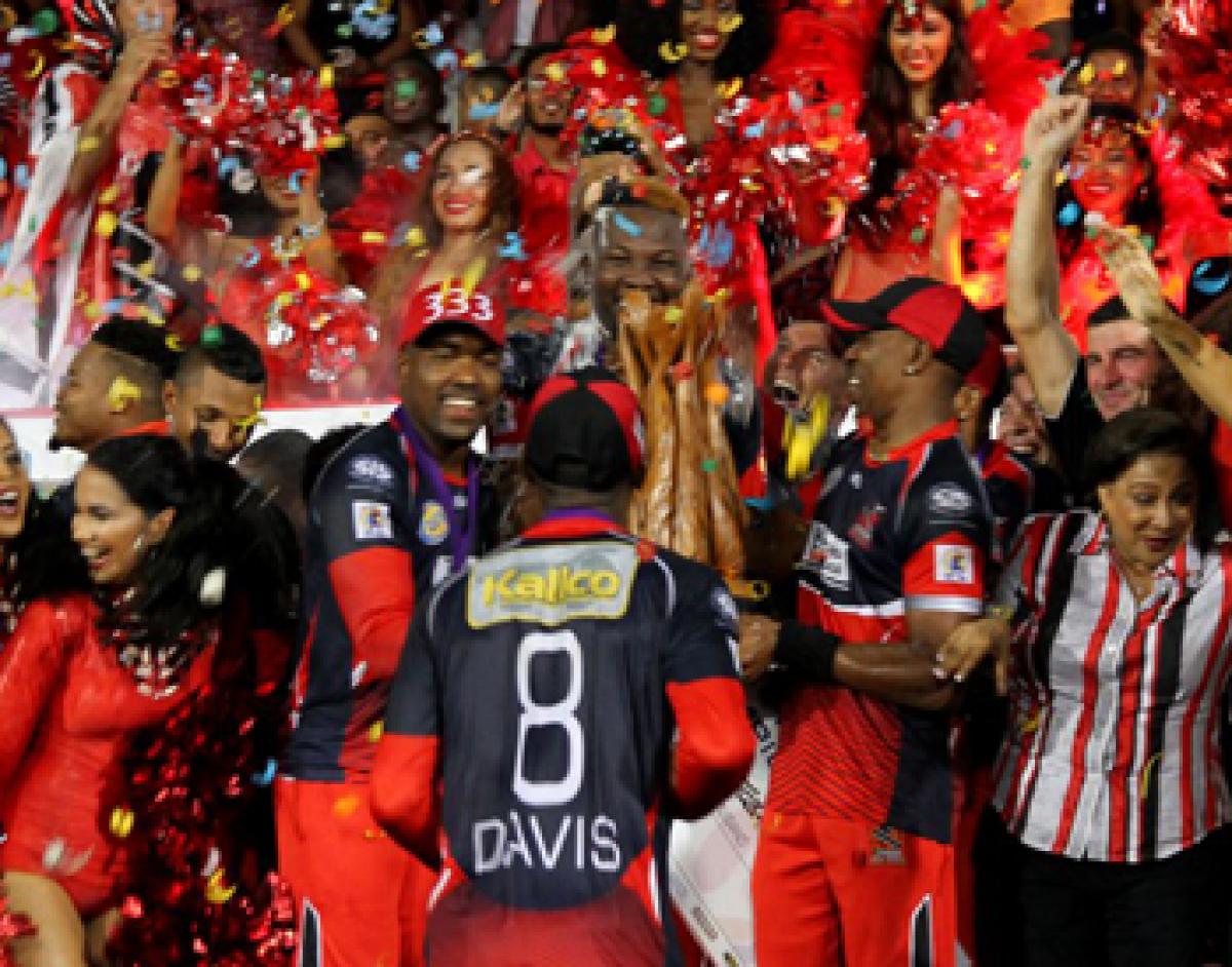 Trinidad & Tobago Red Steel players celebrate with the Caribbean Premier League T20 trophy in Port of Spain
