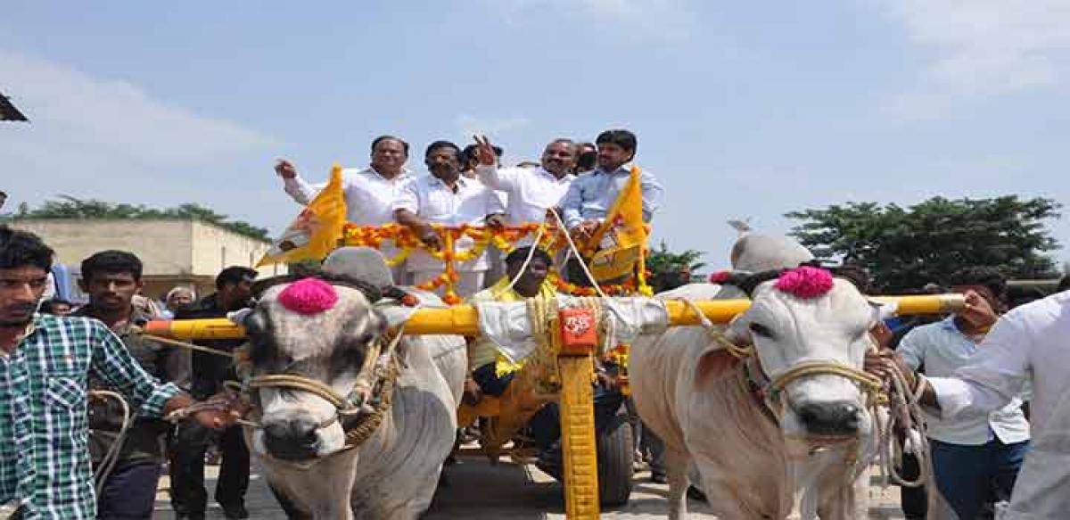 Agriculture Minister Prathipati Pulla Rao greeting people from a bullock cart during Rythu Kosam Chandranna Vijayalu programme at Parchur in Prakasam district on Tuesday. Ministers Sidda Raghava Rao, Kollu Ravindra and TDP leader Karanam Balaram are also seen.
