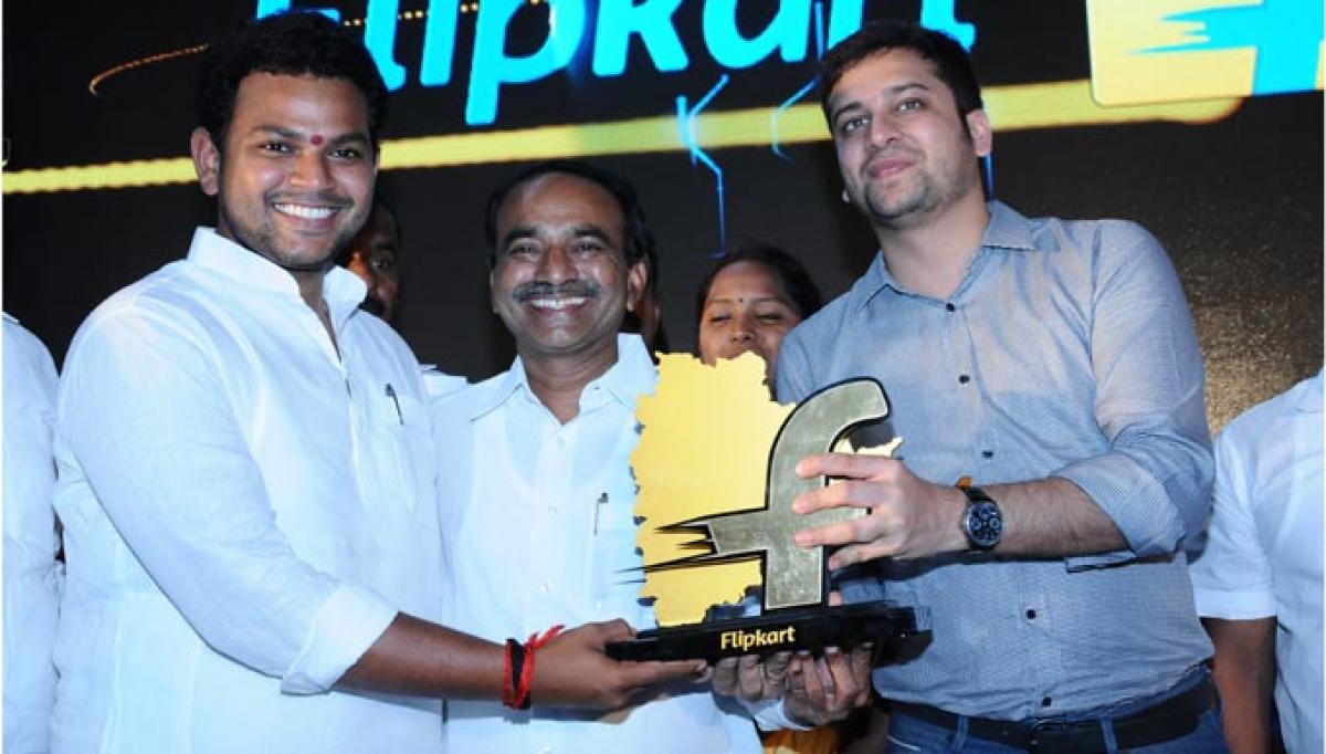 Binny Bansal, COO and co-founder, Flipkart, presenting a memento to Srikakulam MP K Rammohan Naidu at the opening of a fulfillment centre near Medchal on Hyderabad outskirts on Friday. Telangana Finance Minister Etela Rajender (centre) is also seen