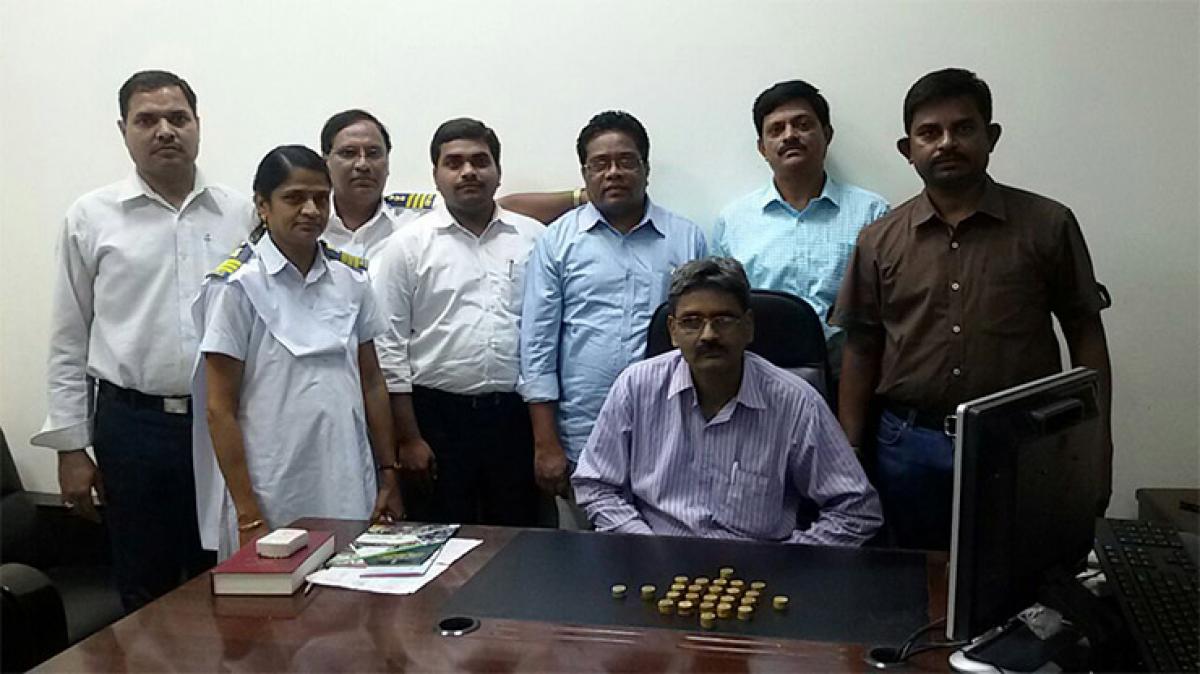 Customs officials displaying the gold coins seized from a passenger at Rajiv Gandhi International Airport in Hyderabad on Monday 