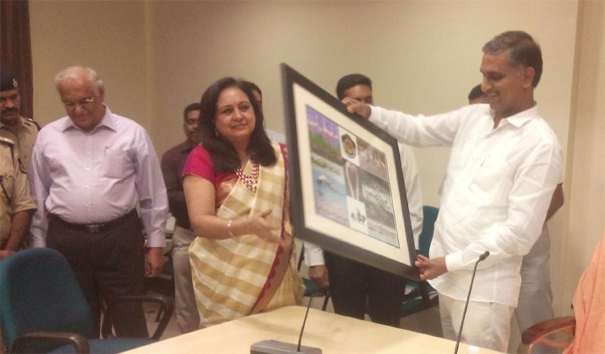 Irrigation Minister T Harish Rao presenting a portrait to Special Protection Force DG Tejdeep Kaur Menon at a review meeting in Hyderabad on Tuesday  