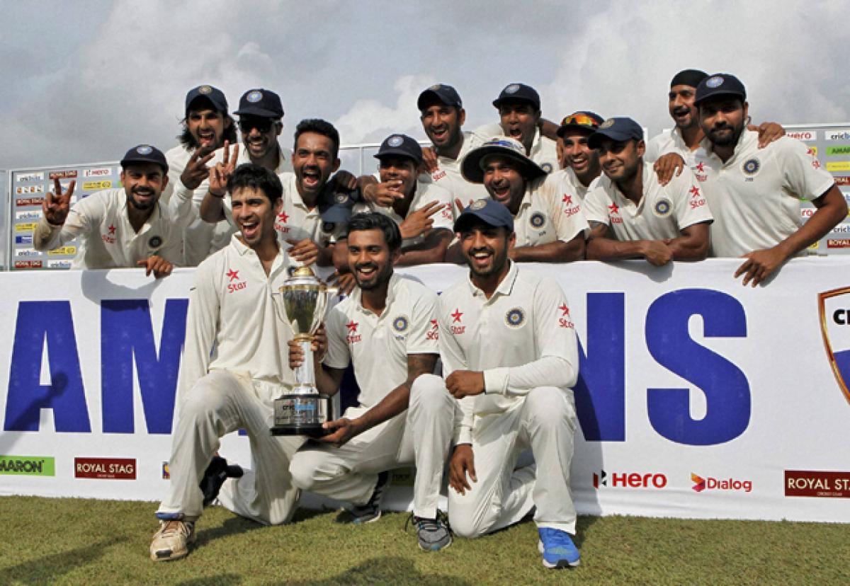 Team India members pose with the trophy after defeating Sri Lanka 2-1 in the three match Test series in Colombo  on Tuesday, India won the deciding  third Test by 117 runs to break a 22-year-jinx in the island-nation.