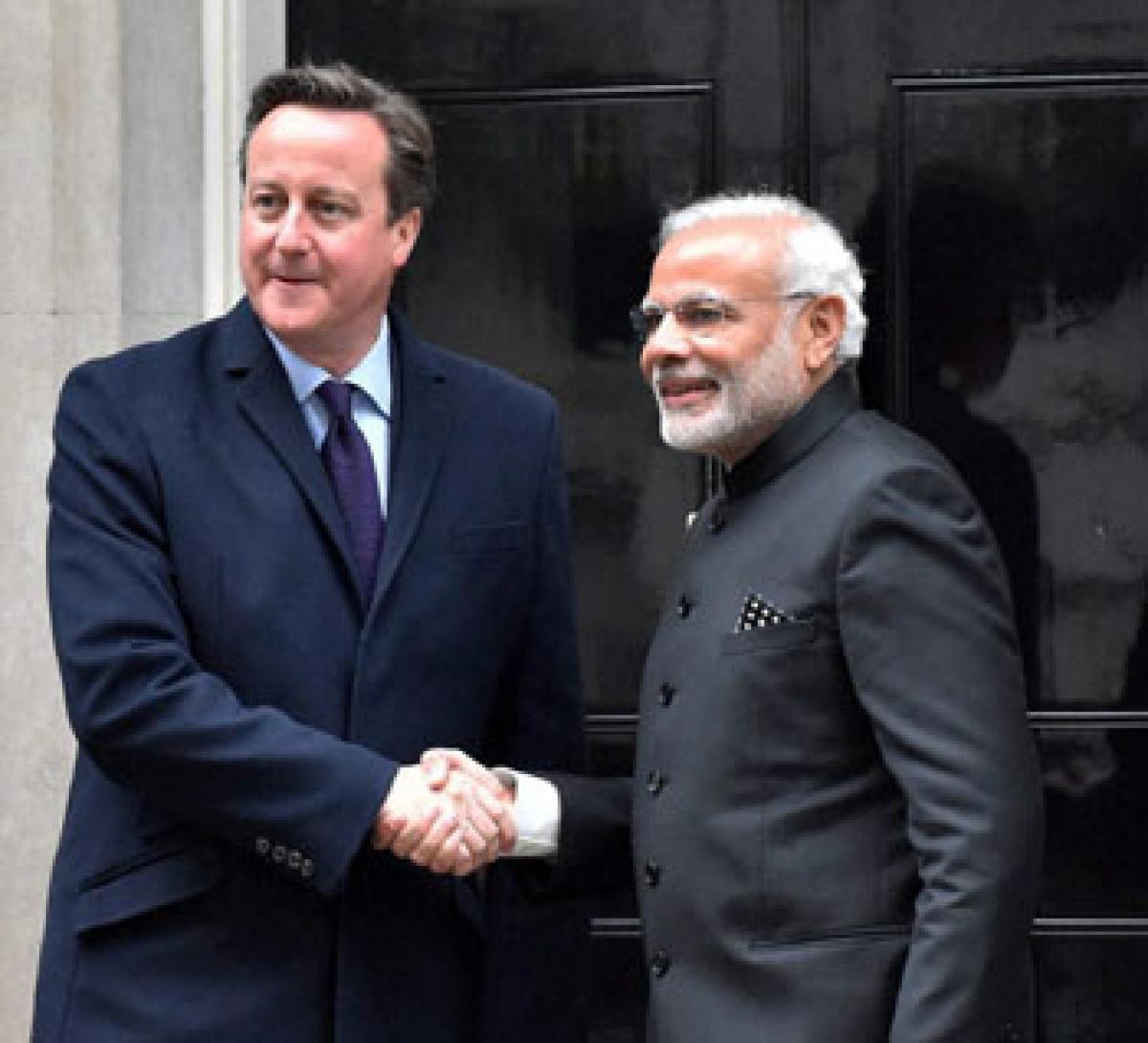 PM Narendra Modi with  British PM David Cameron in London on Thursday