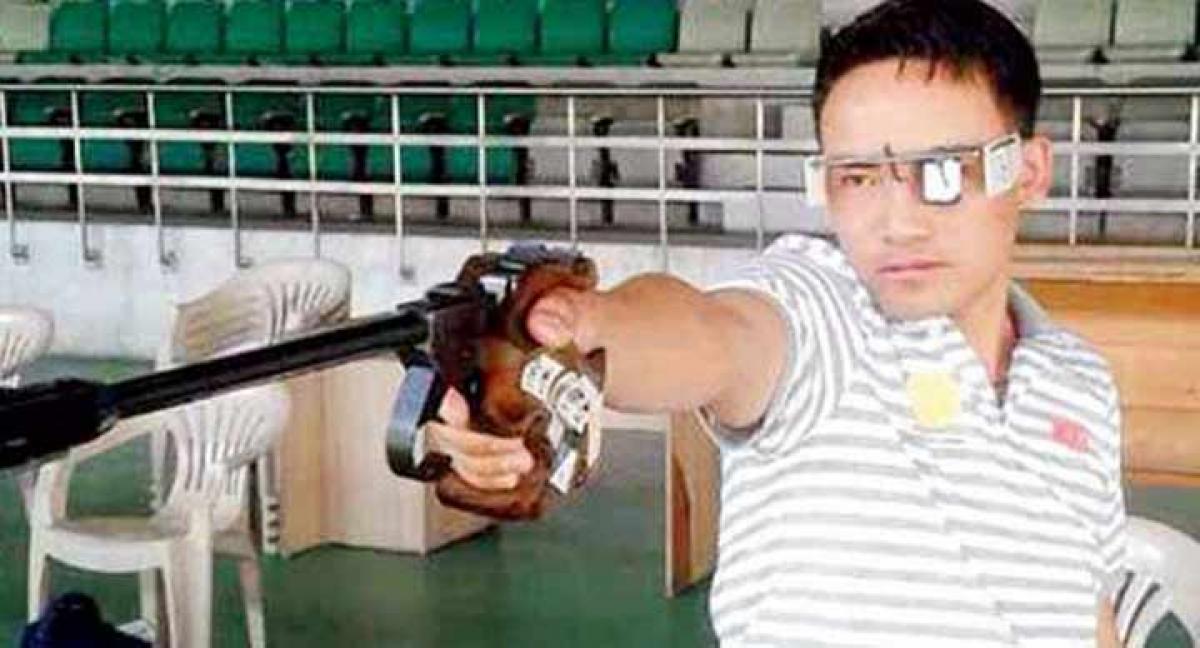 Gold medal winner India's Jitu Rai is al smiles at the podium with the bronze and silver medal winners in the men 50M pistol shooting event on Saturday.