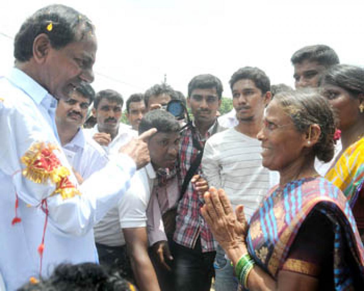 Chief Minister K Chandrashekar Rao interacting with a woman in Gangadevipally village in Warangal district on Monday.