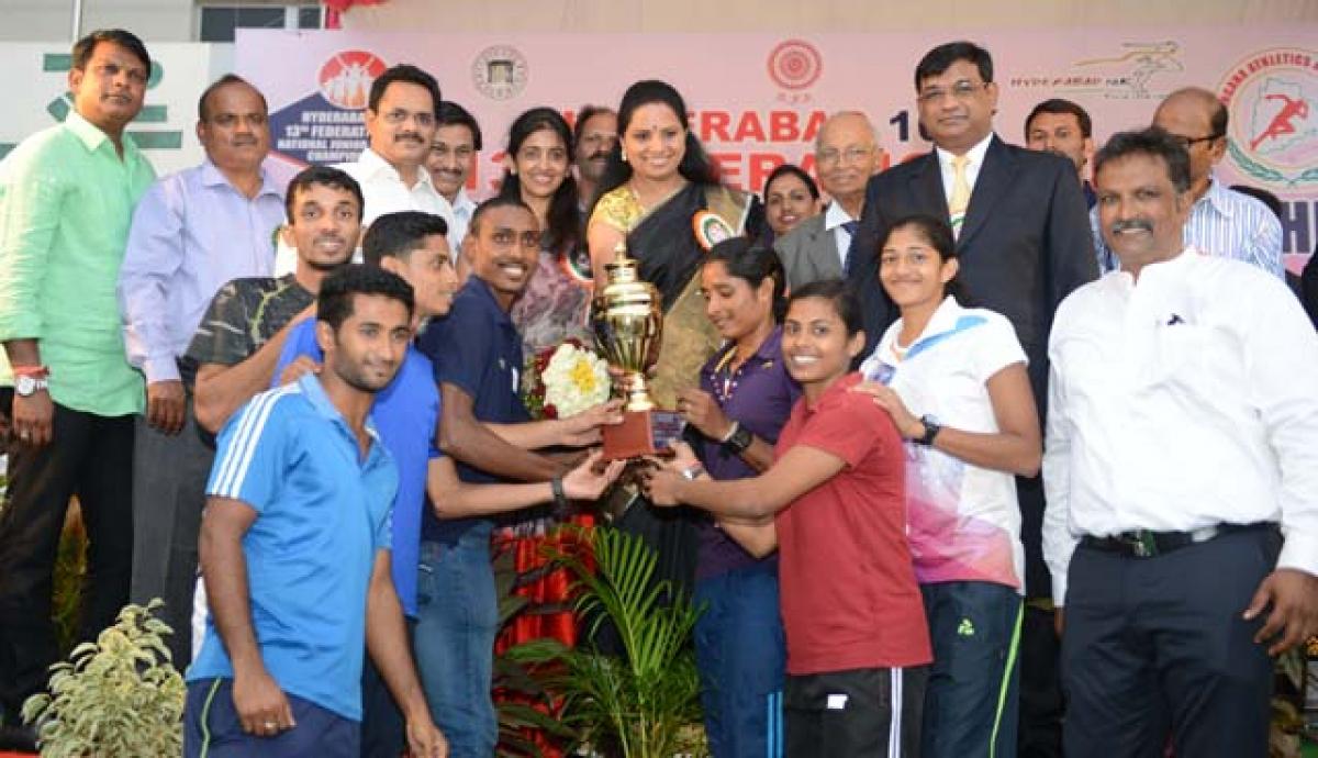  Member of Lok Sabha K Kavitha poses after presenting the overall championship trophy to Kerala team during the closing ceremony of the 13th Federation Cup National Athletics Championship at GMC Balayogi Athletics Stadium in Hyderabad on Sunday. Photo: Saleem