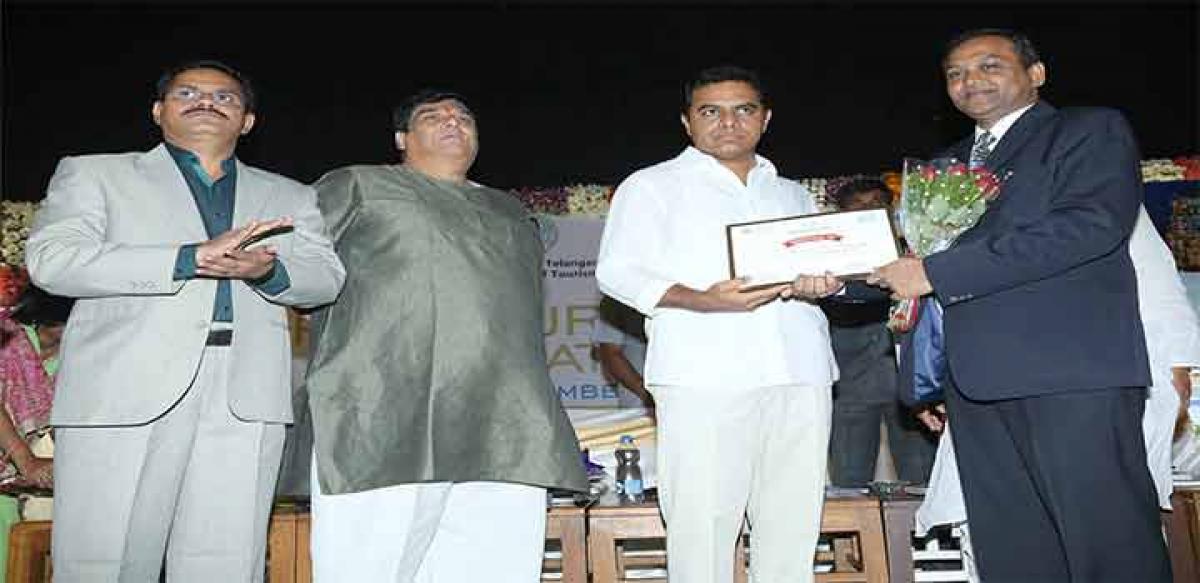 IT and Panchayat Raj Minister K T Rama Rao presenting the Best Domestic Tour Operator Award to Southern Travels representative in Hyderabad 