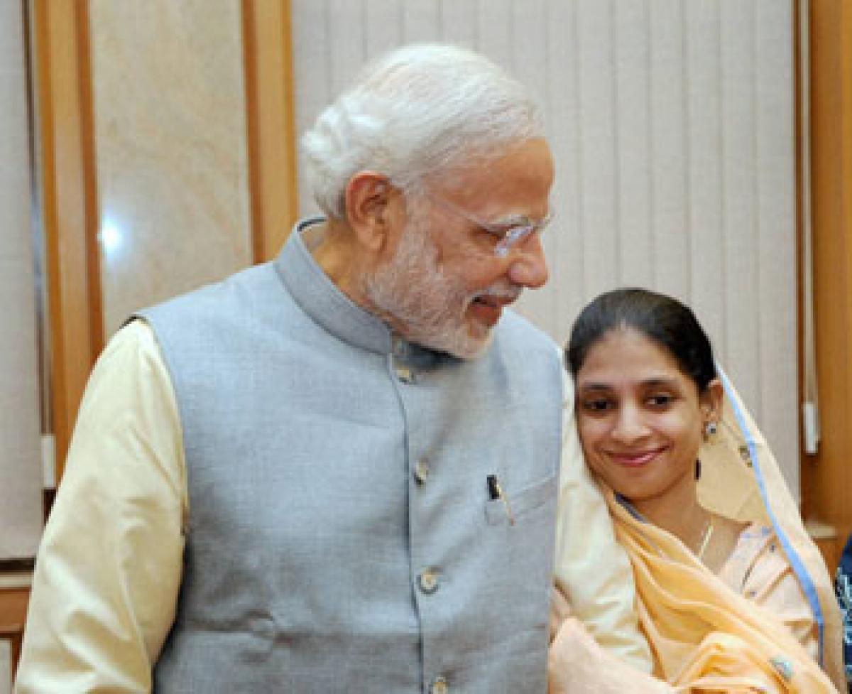 Geeta a deaf-mute Indian woman who accidentally crossed over to Pakistan a decade ago, seen with  Prime Minister Narendra Modi during their meeting after her return to India, in New Delhi on Monday
