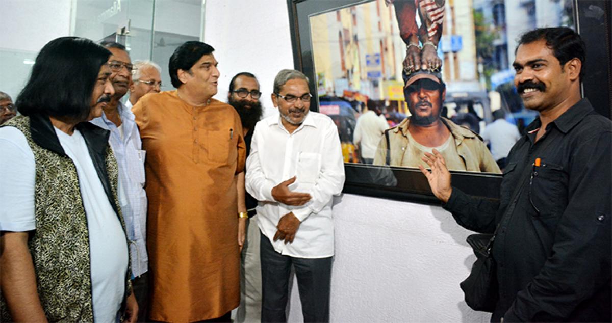 Bharath Bhushan, Ramana Chary and Allam Narayana with Kandukuri Ramesh Babu and his photograph
