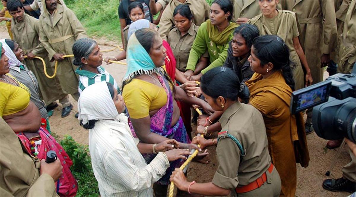 Police trying to prevent tribal farmers from taking up sowing operations on forest land at Ravutla village in Nizamabad district on Thursday 