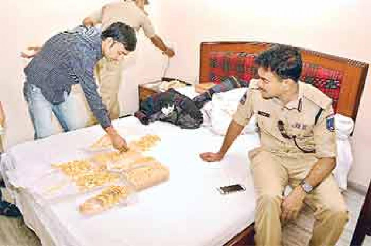 Cyberabad Commissioner of Police C V Anand inspecting the seized gold ornaments at a lodge at Balanagar during an operation on Wednesday 