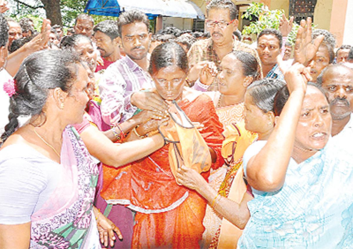 Women comforting a striking municipal worker Shobha who attempted suicide in Warangal on Monday