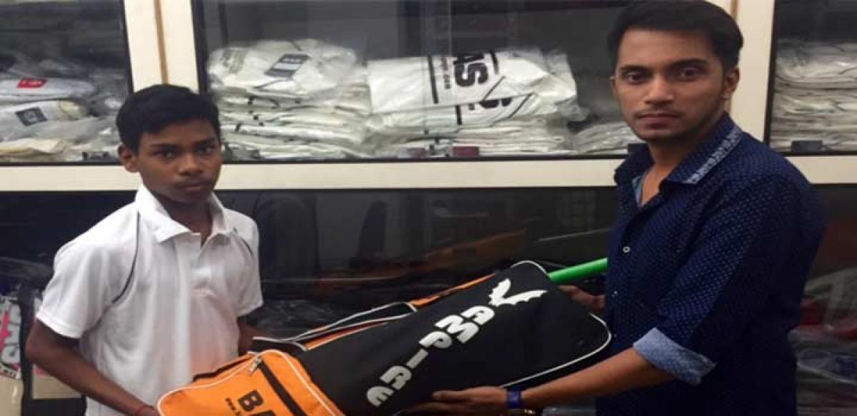 Dhruv Parikh handing over a kit bag