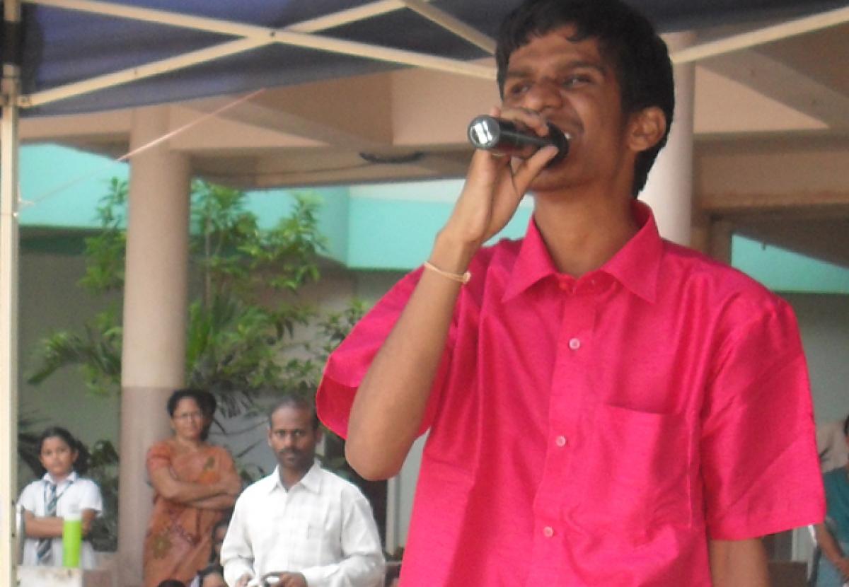 A student of Vijaya Mary School for the Blind performs as students of Delhi Public School enjoy