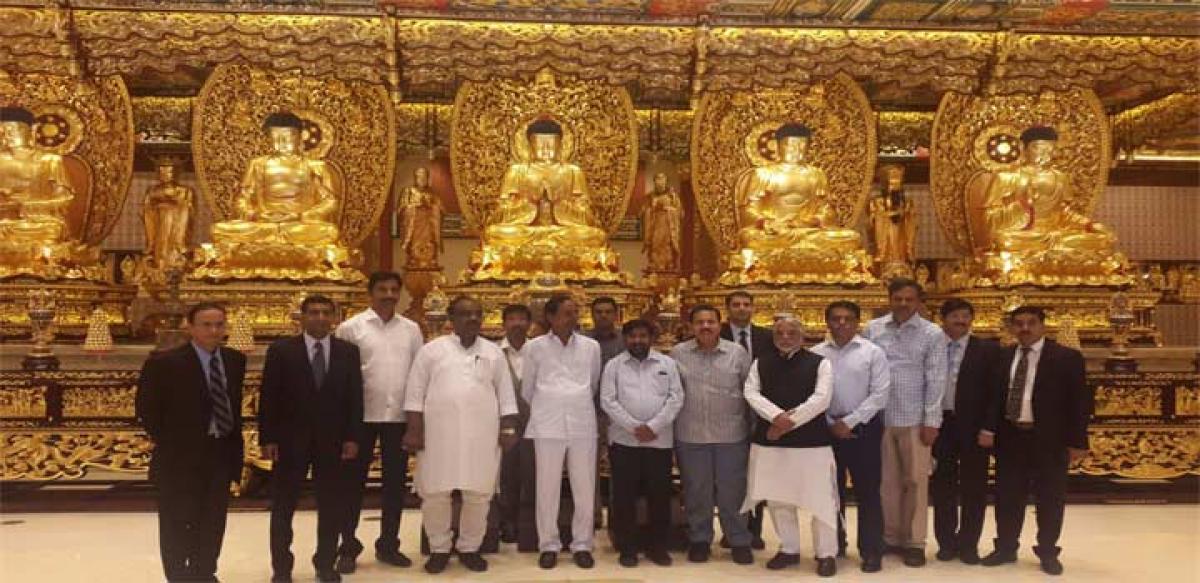 Chief Minister K Chandrashekar Rao and his delegation posing for photograph at the Big Buddha statue generally known as Tian Tan Buddha at Ngong Ping at Lantau Island in Hong Kong on Tuesday