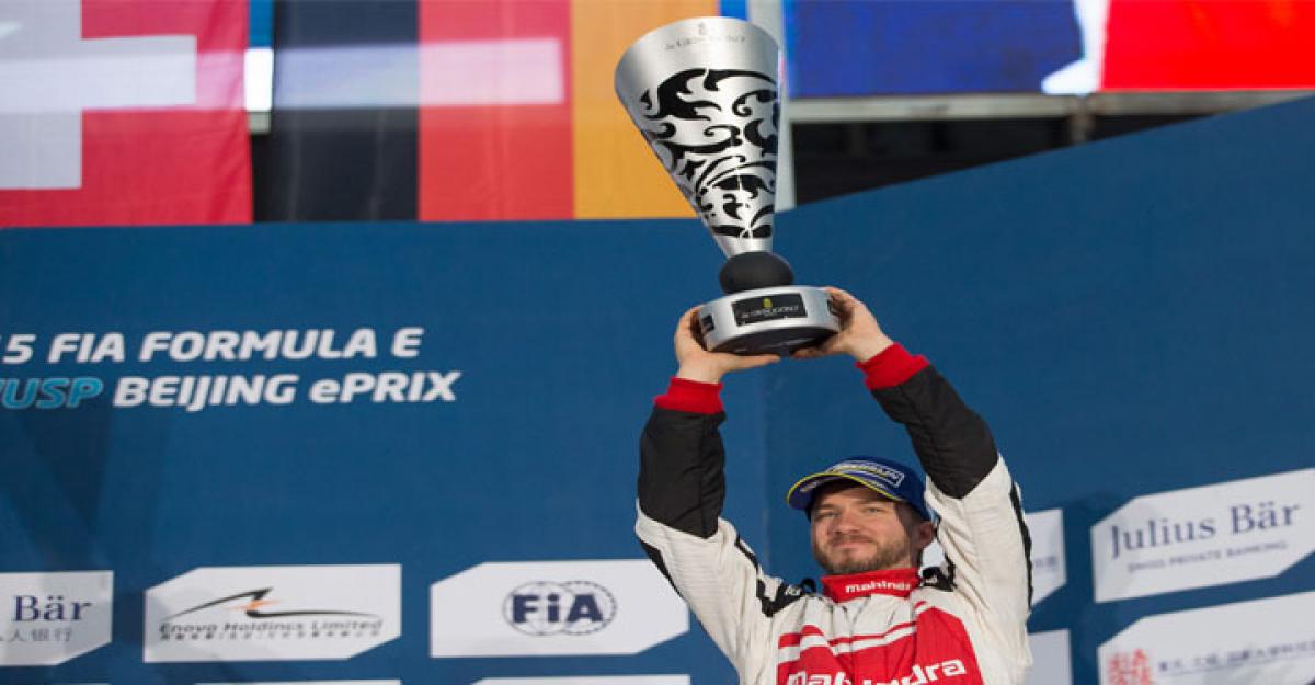 German racer Nick Heidfeld poses with the trophy after securing Mahindra Racing's first ever podium in Formula E