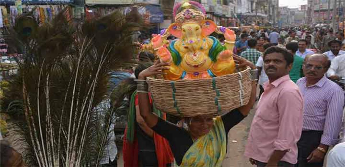 BIG CATCH! : A devotee transporting a Ganesh idol in a basket on her on the eve of Vinayaka Chavithi at Monda Market in Hyderabad on Wednesday  	Photo: Ch Prabhu Das