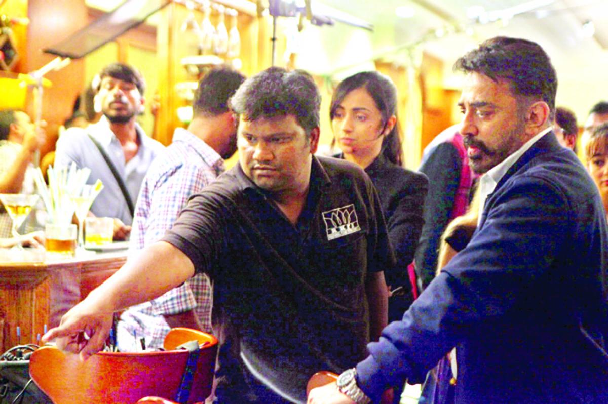 On location: Rajesh giving instructions to Kamal. Trisha is also seen in the background