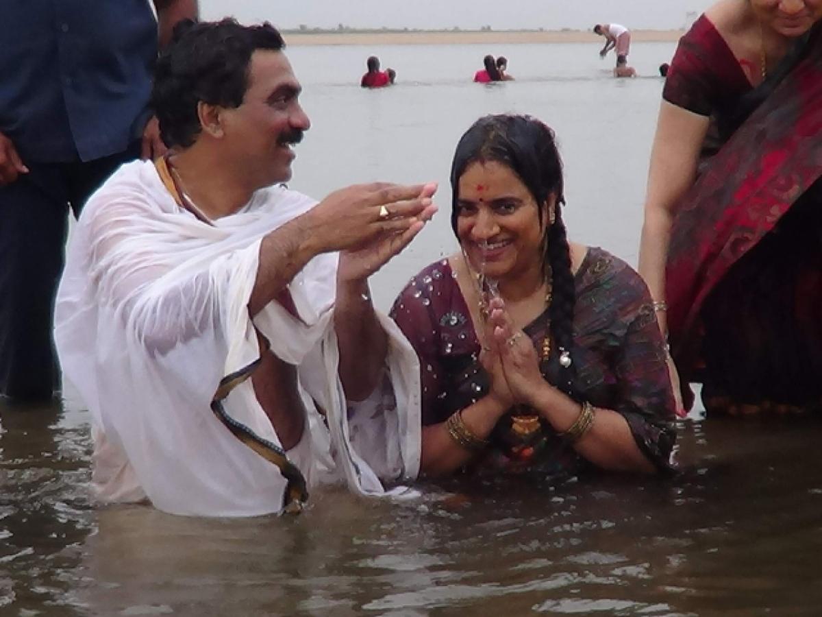 Former MP Lagadapati Rajagopal, along with his wife, taking holy dip in Godavari river at Kaleshwaram on Sunday