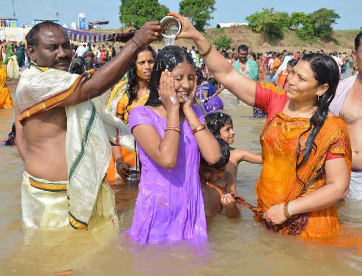 Members of a family after a holy dip at Mangapet Pushkar ghat in Warangal district