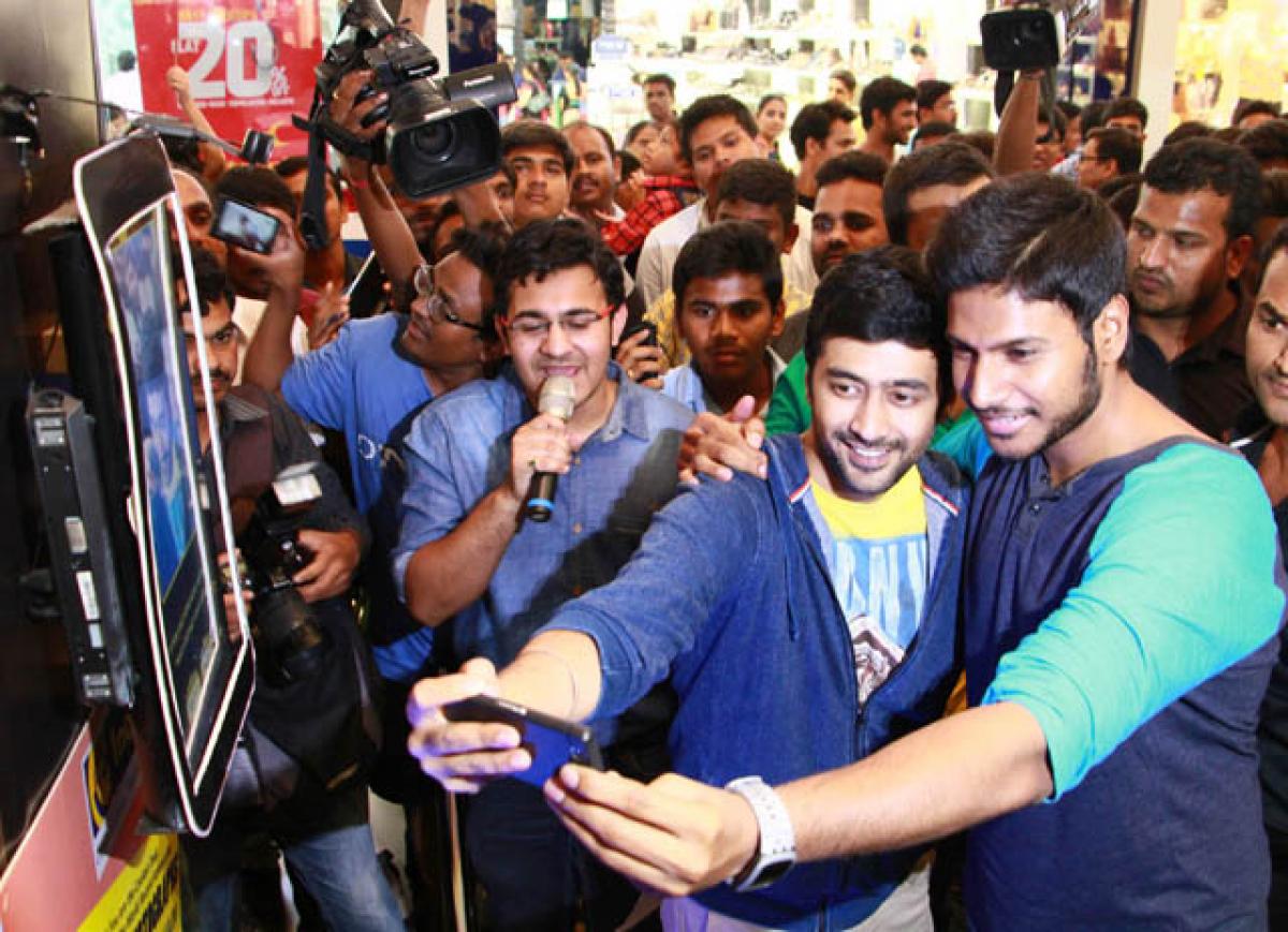 Actors Rahul and Sundeep taking a selfie at the event