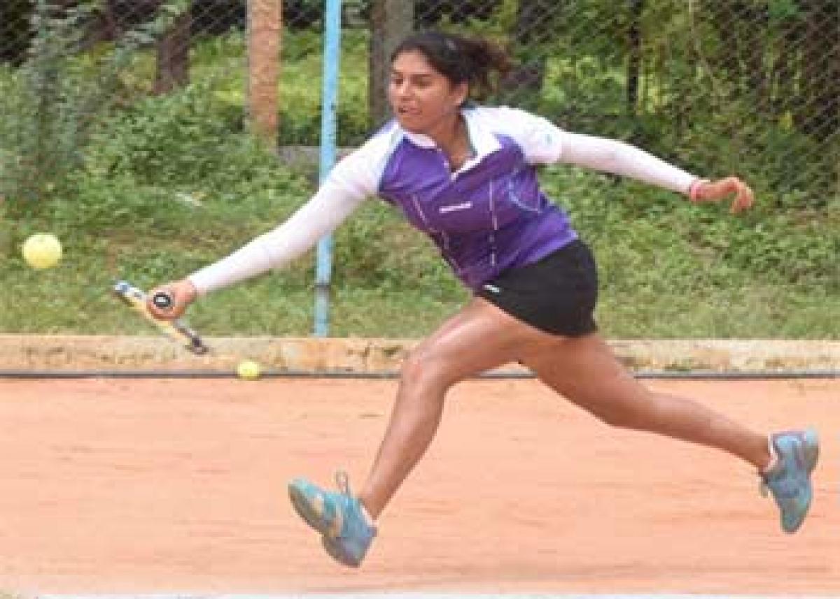 Prerna Bhambri plays a forehand shot against Rishika Sunkara in the semifinals of the Phoenix Live  ITF Woman Championship in Hyderabad on Friday. Photo: Saleem