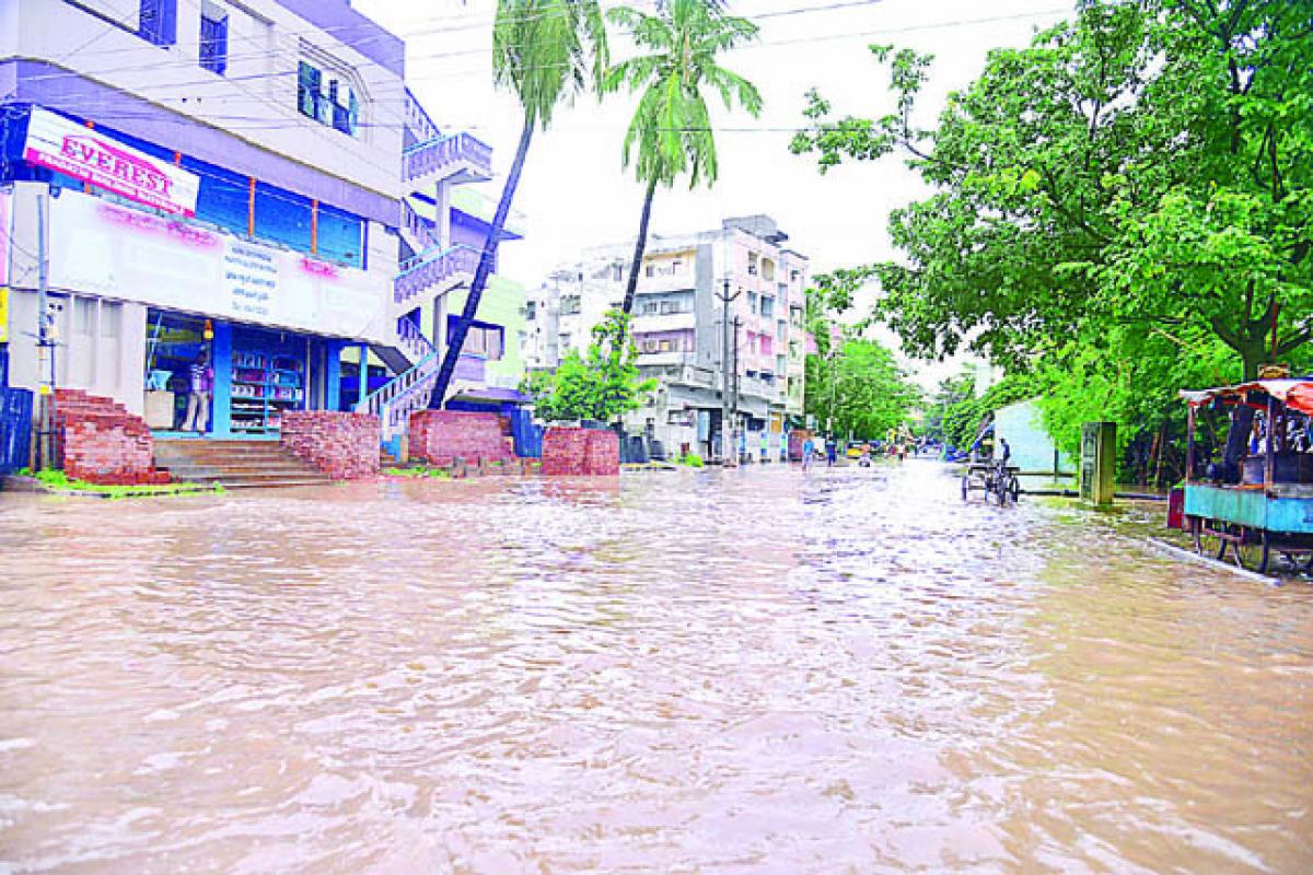 Railway Station road turns into a stream due to heavy rain in Rajahmundry on Sunday