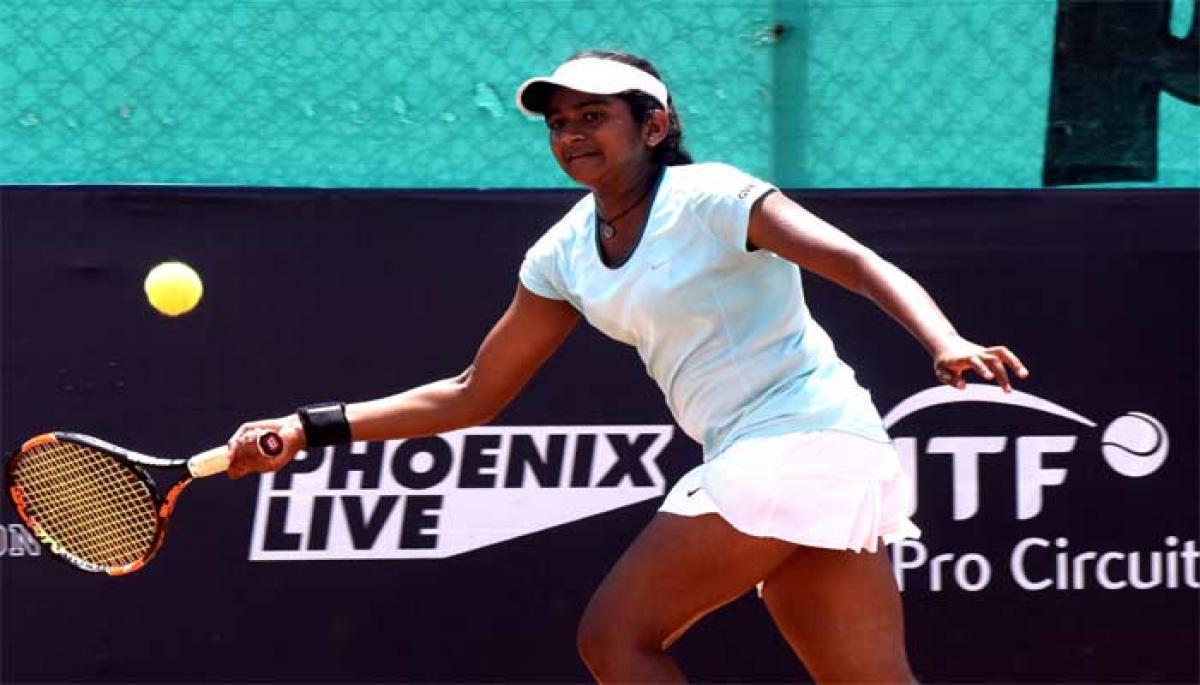 Pranjala Yadlapalli plays a forehand shot against Snehadevi Reddy  in the pre -quarterfinals of the ITF women championship in Hyderabad on Wednesday. Photo: Saleem