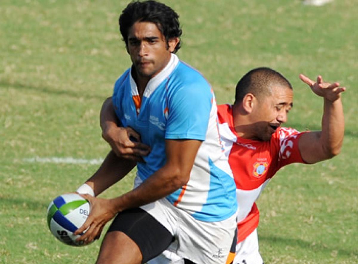 XIX Commonwealth Games-2010 Delhi: (Rugby) India player being chased by Maafu of Tonga at Delhi University in New Delhi on October 11, 2010