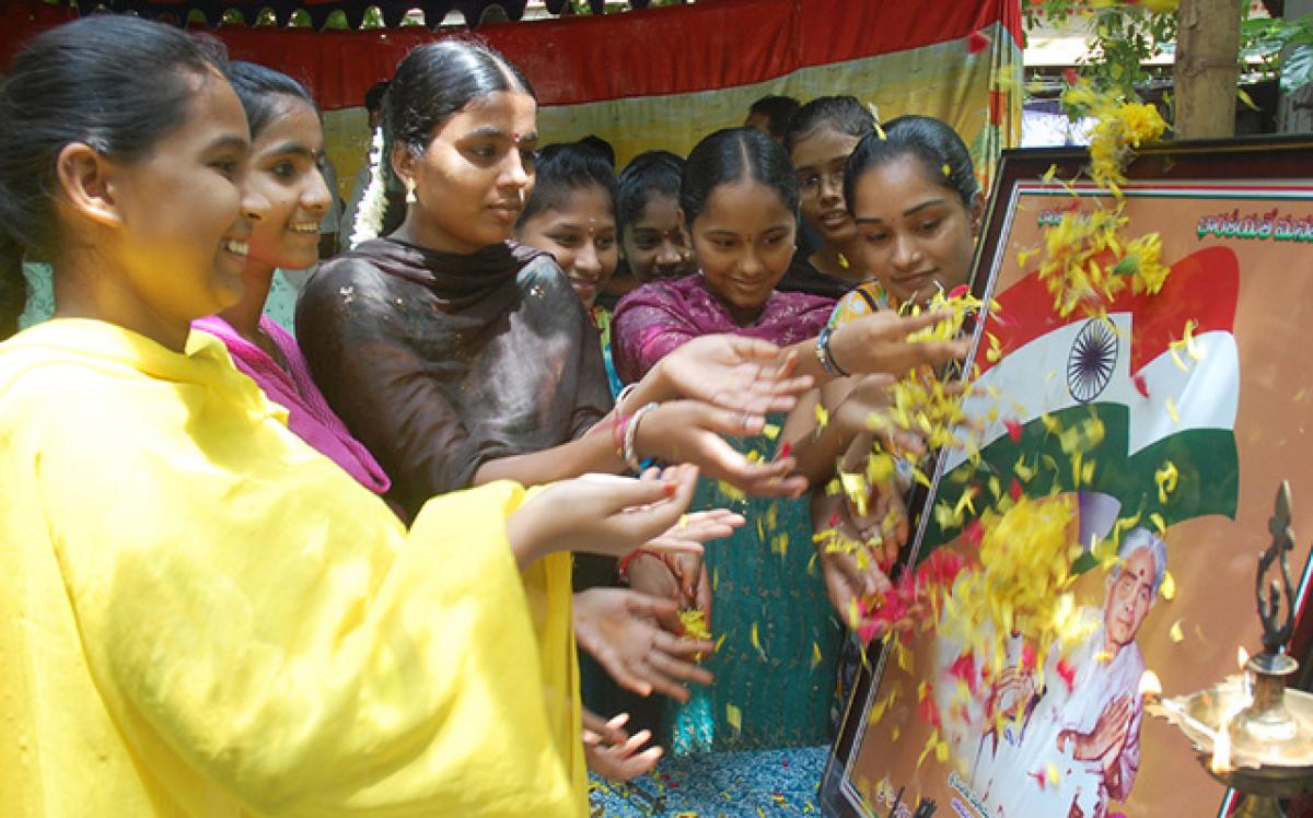 Students paying floral tributes to the portrait of Pingali Venkayya at a programme held at Navabharat Public School in Vijayawada on Sunday to mark the 138th birth anniversary of the designer of  National Flag (Hans Photo N Kishore)  