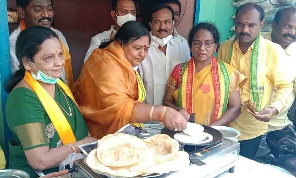 TDP MP candidate Panabhaka Lakshmi making dosas during election campaign at Sundharaiah Nagar in Tirupati on Wednesday