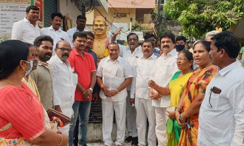 Endowments Minister Velampalli Srinivas and party leaders paying tributes to Babu Jagjivan Ram on the occasion of his birth anniversary in Vijayawada on Monday